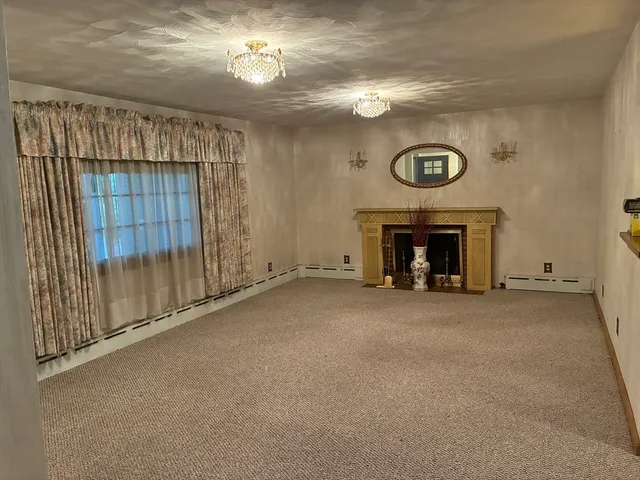 a view of empty room with a fireplace