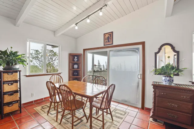 a view of a dining room with furniture and window