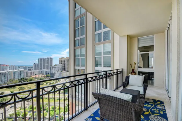 a view of a balcony with furniture and city view