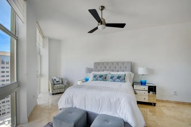 a bedroom with a large bed and a large window