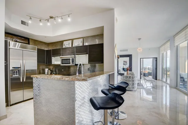 a kitchen with cabinets appliances and a sink