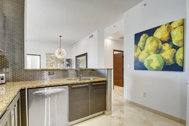 a kitchen with refrigerator and cabinets