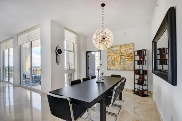 a view of a dining room with furniture and chandelier