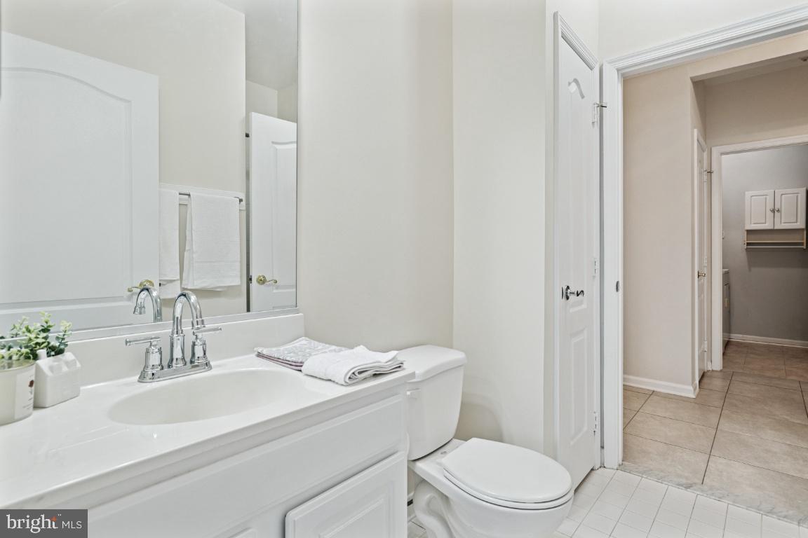 20903 Cedarpost Square, Unit 101 Ashburn, VA 20147 - Photo 14 of 26 a bathroom with a sink toilet and shower