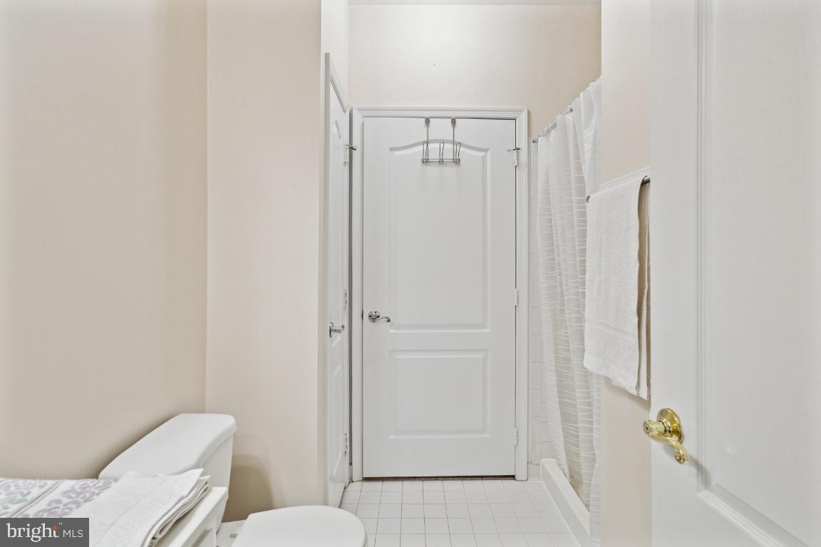 20903 Cedarpost Square, Unit 101 Ashburn, VA 20147 - Photo 16 of 26 a bathroom with a toilet and shower