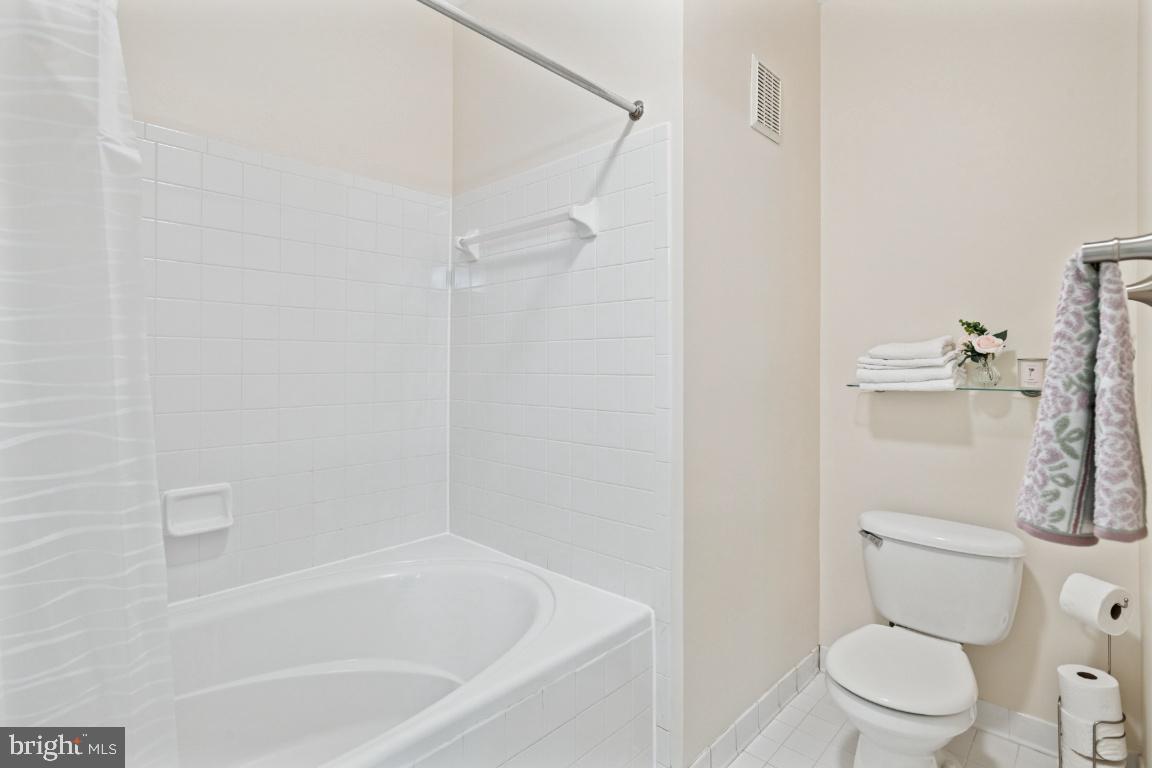 20903 Cedarpost Square, Unit 101 Ashburn, VA 20147 - Photo 20 of 26 a white toilet sitting next to a bath tub