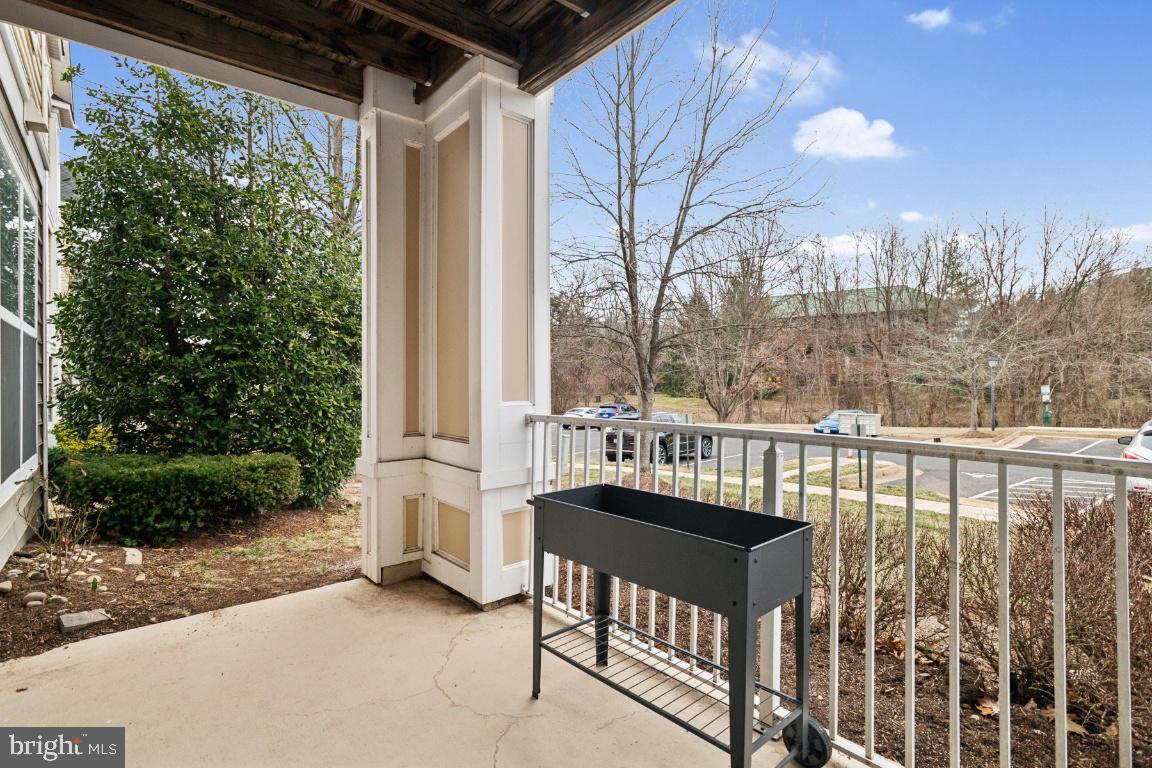 20903 Cedarpost Square, Unit 101 Ashburn, VA 20147 - Photo 22 of 26 a view of a balcony with chairs and wooden fence