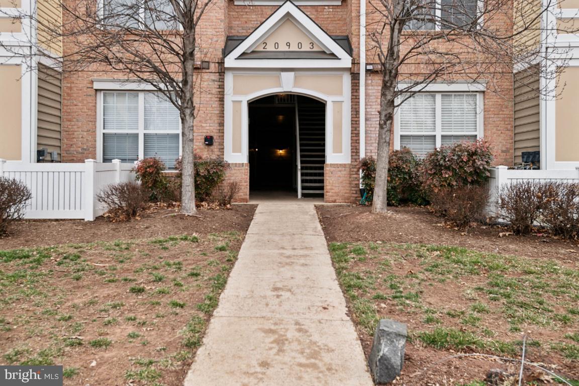 20903 Cedarpost Square, Unit 101 Ashburn, VA 20147 - Photo 24 of 26 a front view of a house with a garden