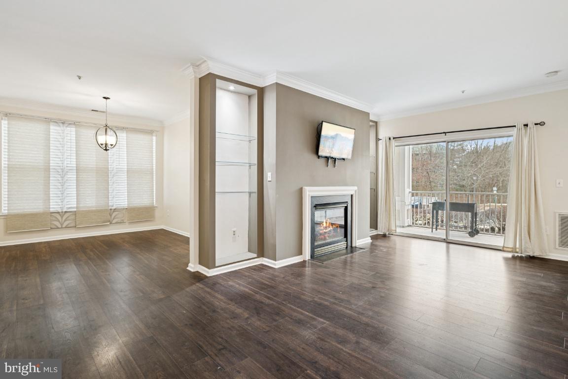 20903 Cedarpost Square, Unit 101 Ashburn, VA 20147 - Photo 5 of 26 a view of an empty room with wooden floor and a window