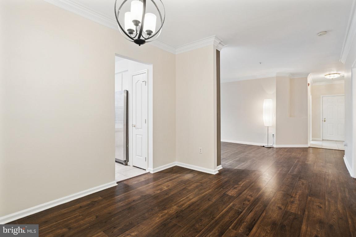 20903 Cedarpost Square, Unit 101 Ashburn, VA 20147 - Photo 8 of 26 an empty room with wooden floor and mirror