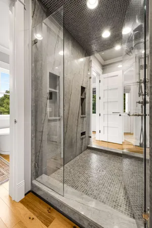 a view of a bathroom with a glass door shower