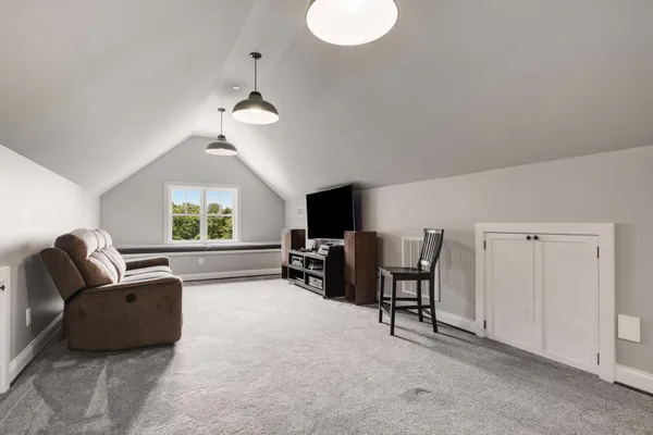 a living room with furniture a flat screen tv and a large window