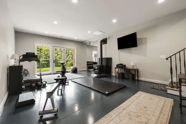 a living room with furniture floor to ceiling window and a flat screen tv