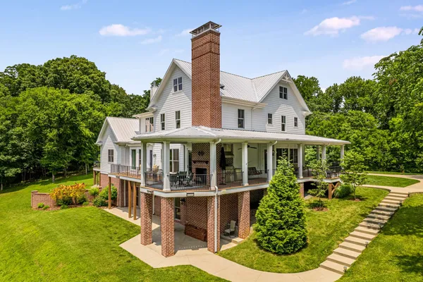 a front view of a house with a yard table and chairs