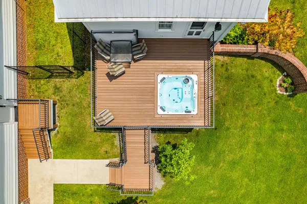 an aerial view of residential houses with outdoor space and trees