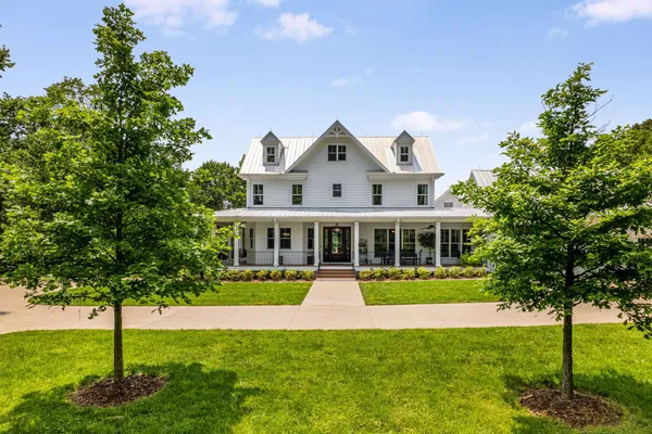 a front view of a house with a yard table and chairs