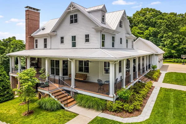 a view of a house with yard and sitting area