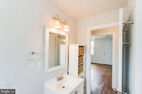 a bathroom with a sink a mirror and shower