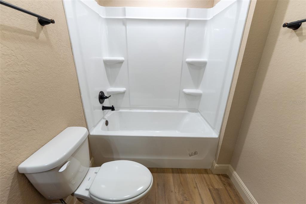5845 Northwest 65th Street Ocala, FL 34482 - Photo 48 of 63 a bathroom with a toilet and bathtub