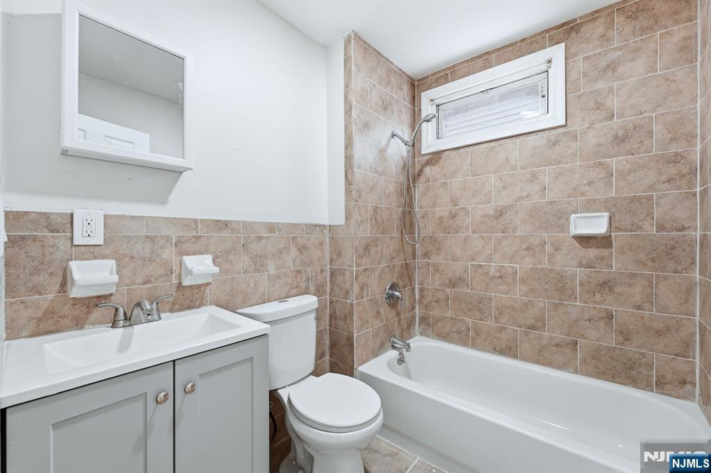 72 South 13th Street Newark, NJ 07107 - Photo 11 of 40 a bathroom with a sink a toilet and shower