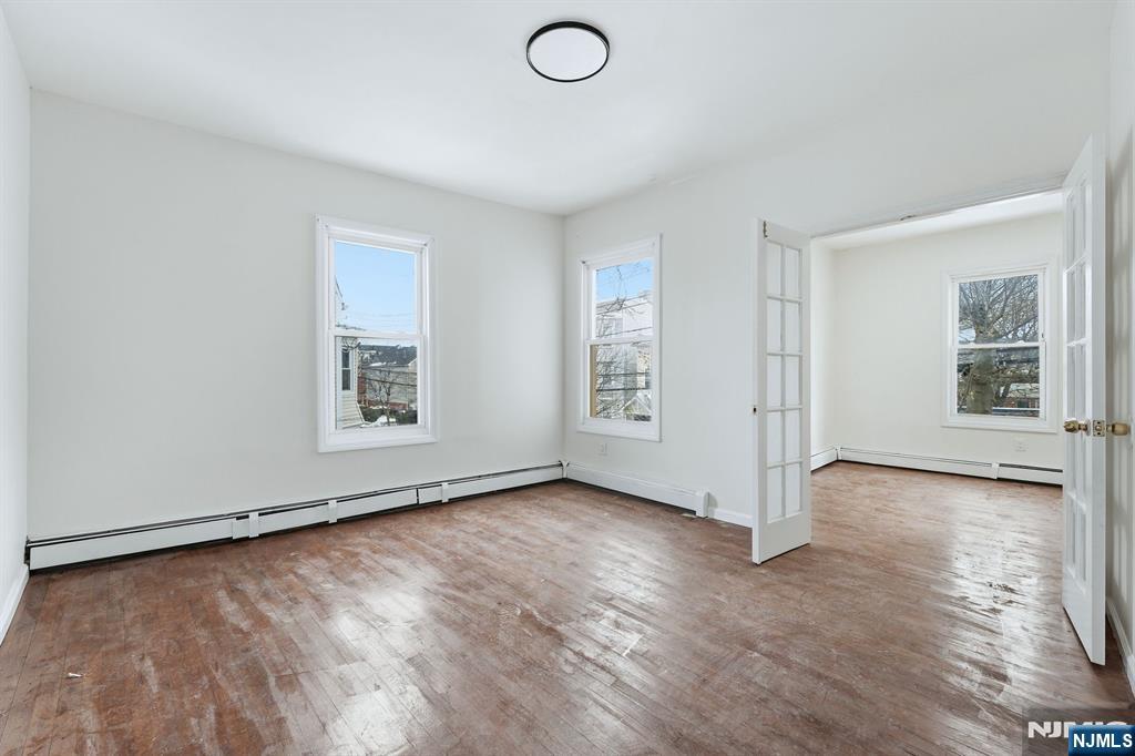 72 South 13th Street Newark, NJ 07107 - Photo 14 of 40 an empty room with windows & dryer