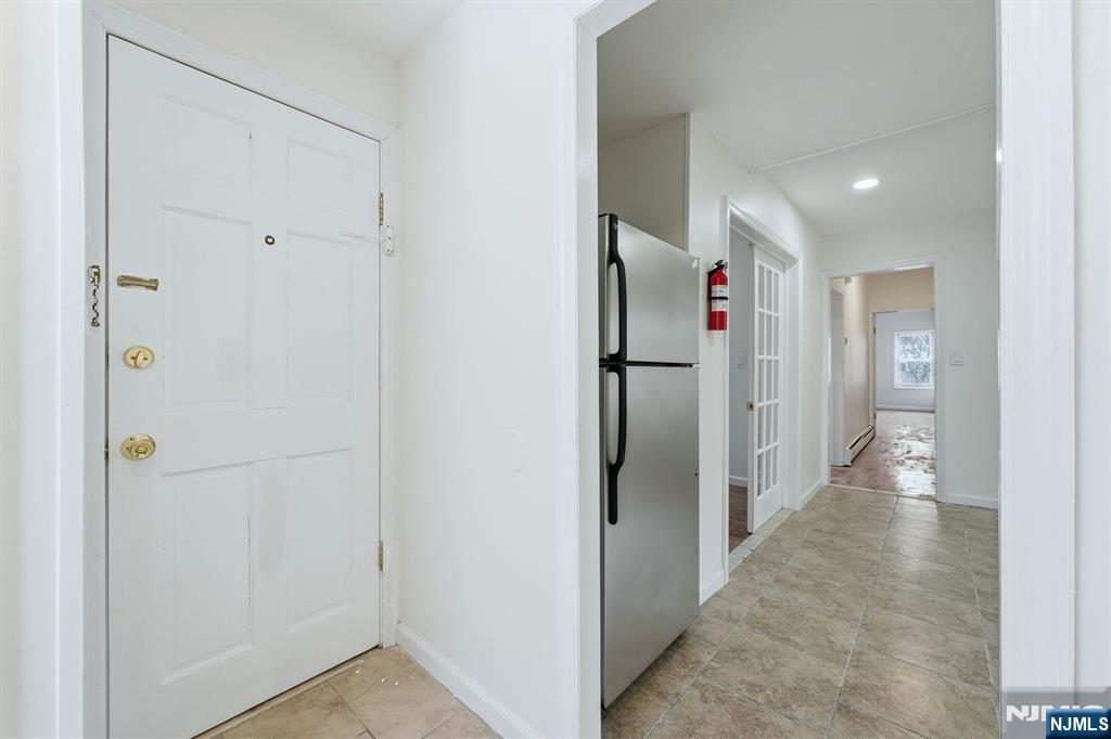 72 South 13th Street Newark, NJ 07107 - Photo 18 of 40 a view of a hallway with wooden shelves