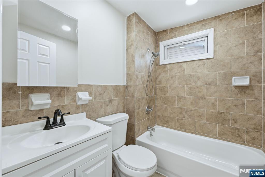 72 South 13th Street Newark, NJ 07107 - Photo 19 of 40 a bathroom with a sink a toilet and bathtub