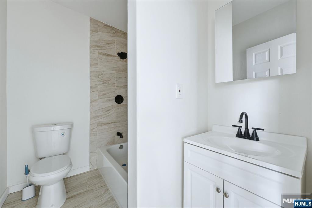 72 South 13th Street Newark, NJ 07107 - Photo 34 of 40 a bathroom with a toilet sink and shower