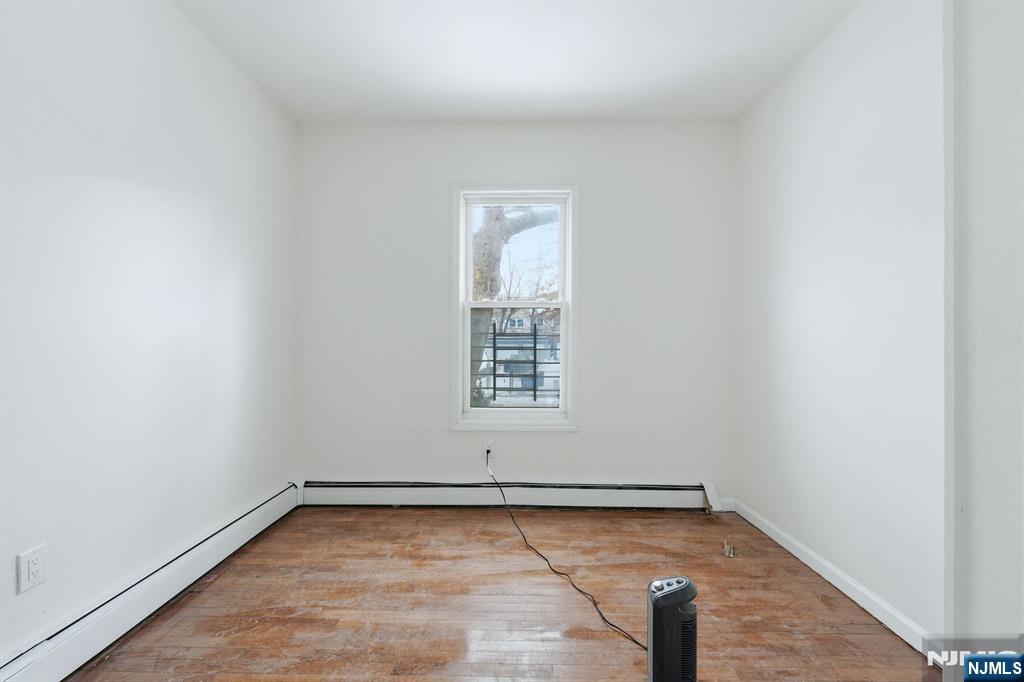 72 South 13th Street Newark, NJ 07107 - Photo 10 of 40 a view of a room with wooden floor and window