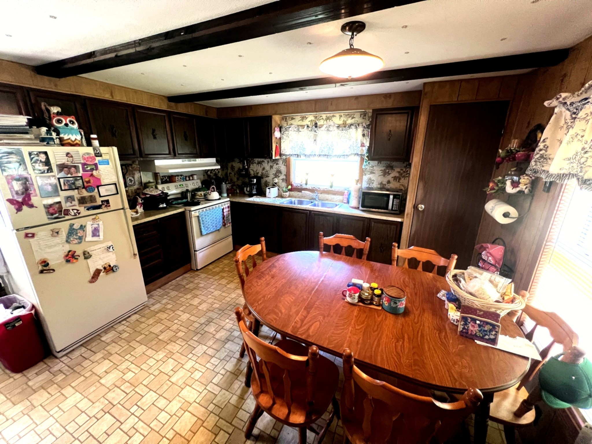 1133 Culps Bend Road Clifton, TN 38425 - Photo 11 of 51 a kitchen with stainless steel appliances granite countertop a sink dishwasher and a refrigerator with wooden floor