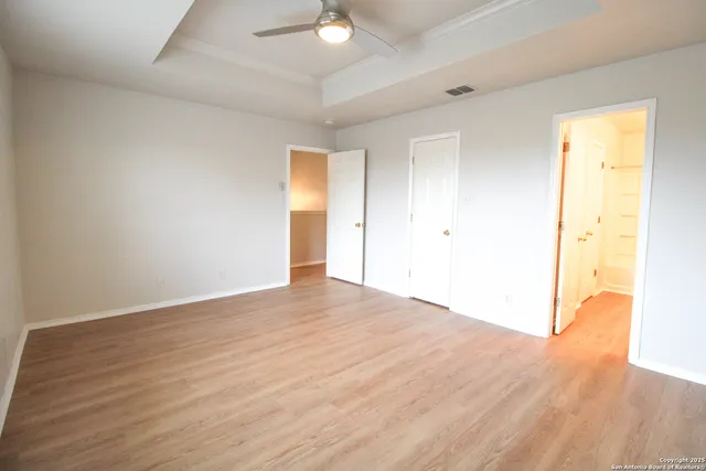 a view of an empty room and wooden floor