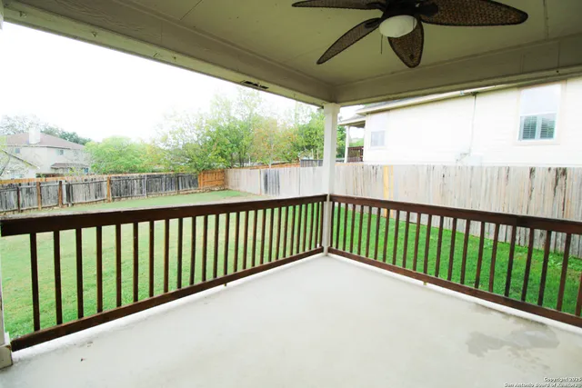 a view of a yard with a wooden fence