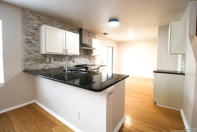 a kitchen with a sink and a refrigerator