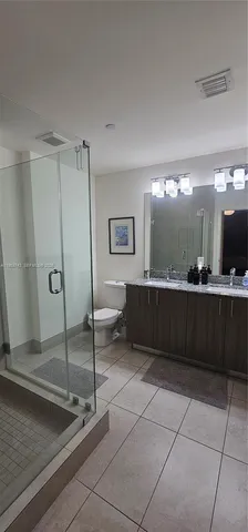 a bathroom with a sink a mirror and a shower
