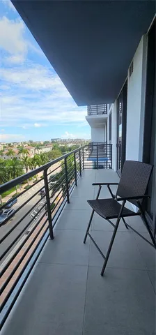 a view of a chairs and table in the balcony