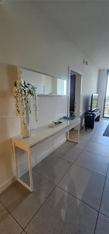 a lobby with furniture and chandelier