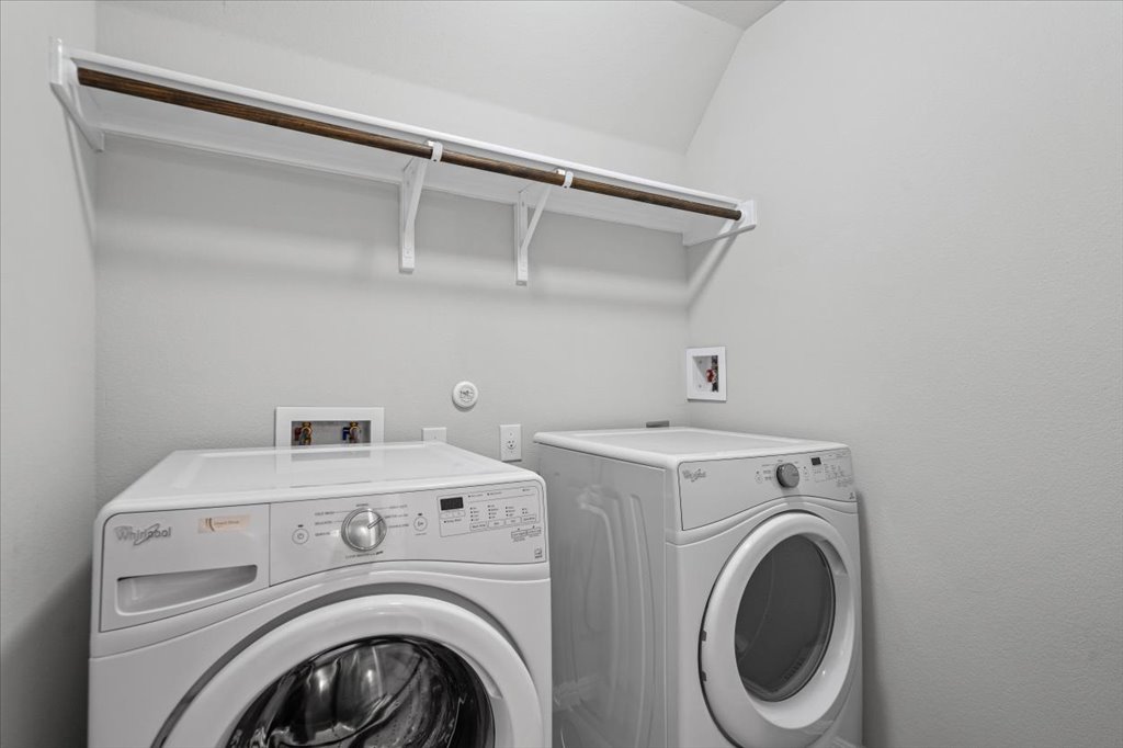 1502 Airedale Road, Unit 2502 Austin, TX 78748 - Photo 24 of 28 Functional laundry room offers a convenient upper shelf for storage and a hanging rod for garments.