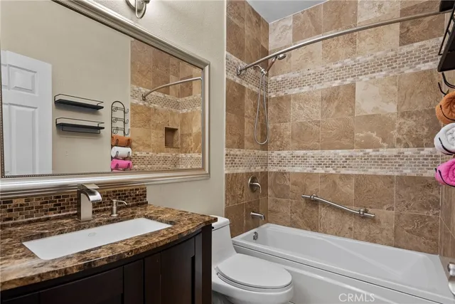 a view of a chair and table in the back yard of the house
