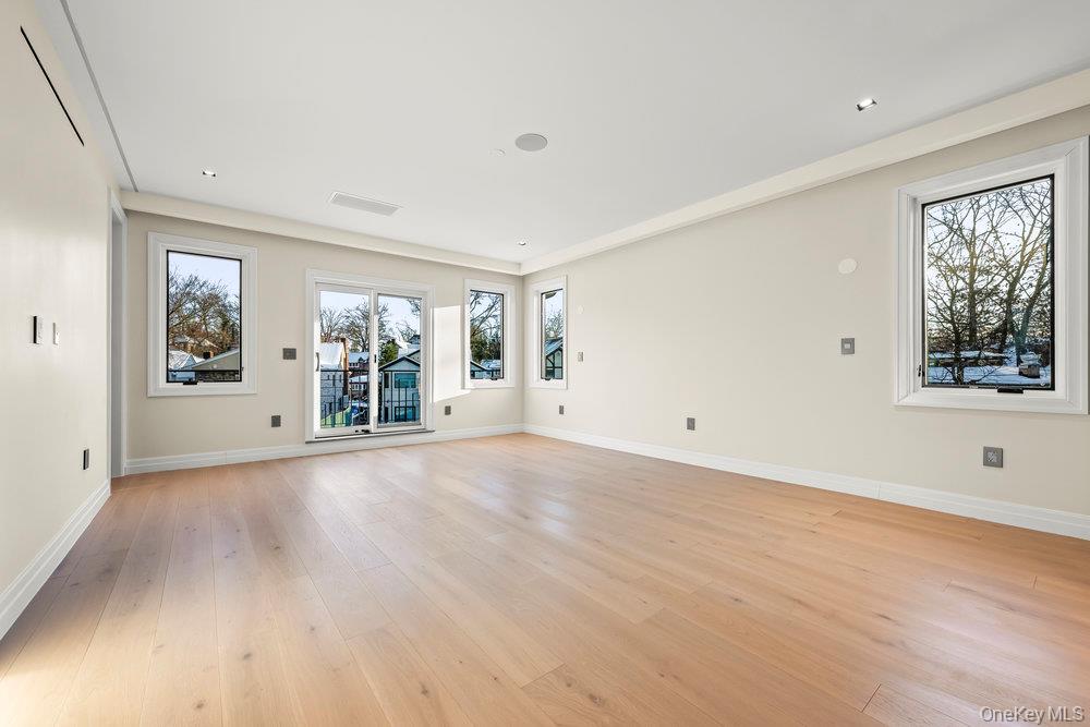 176-12 Kildare Road Queens, NY 11432 - Photo 18 of 34 a view of a big room with wooden floor and windows