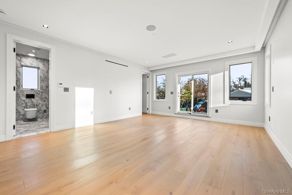 176-12 Kildare Road Queens, NY 11432 - Photo 20 of 34 wooden floor in an empty room with a window