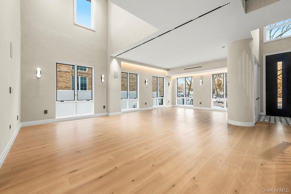 176-12 Kildare Road Queens, NY 11432 - Photo 2 of 34 an empty room with wooden floor and windows