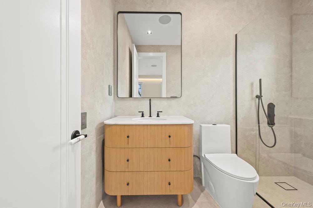 176-12 Kildare Road Queens, NY 11432 - Photo 23 of 34 a bathroom with a granite countertop toilet sink and mirror