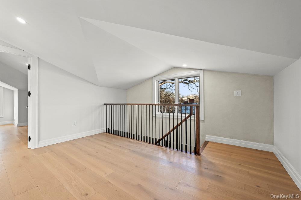 176-12 Kildare Road Queens, NY 11432 - Photo 24 of 34 a view of a hallway with wooden floor and windows