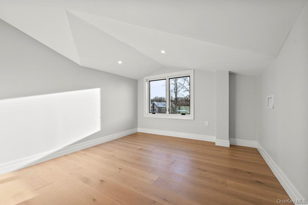 176-12 Kildare Road Queens, NY 11432 - Photo 25 of 34 an empty room with wooden floor and windows