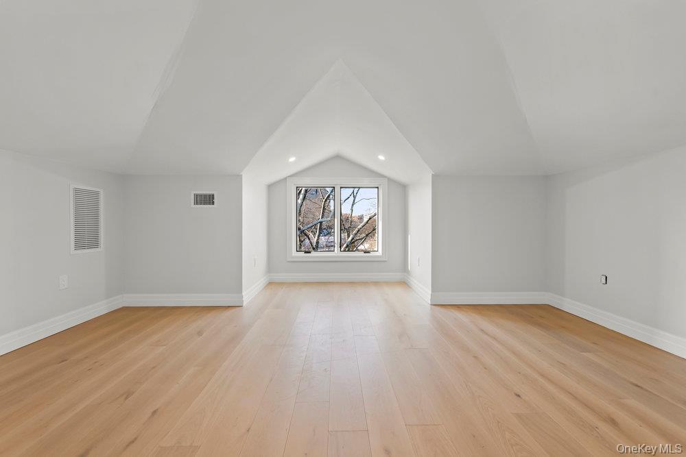 176-12 Kildare Road Queens, NY 11432 - Photo 26 of 34 Additional living space featuring lofted ceiling and light wood-style floors