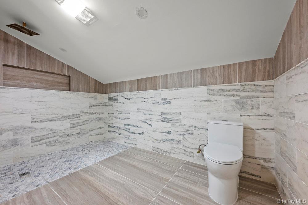 176-12 Kildare Road Queens, NY 11432 - Photo 29 of 34 Full bathroom with a tile shower and lofted ceiling