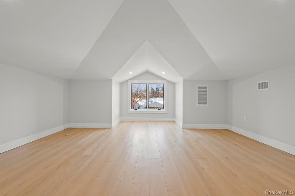 176-12 Kildare Road Queens, NY 11432 - Photo 31 of 34 Additional living space with light wood-style floors and lofted ceiling
