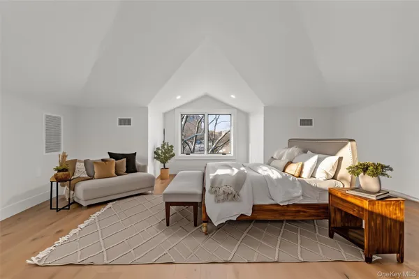 a bed room with a bed and a chair