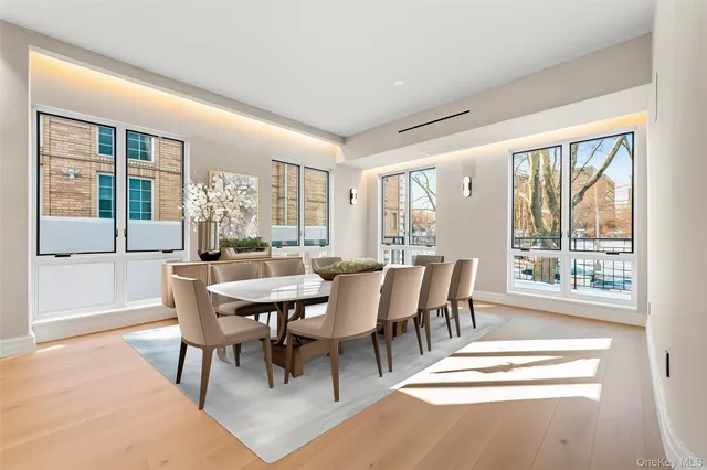 a view of a dining room with furniture large windows and wooden floor