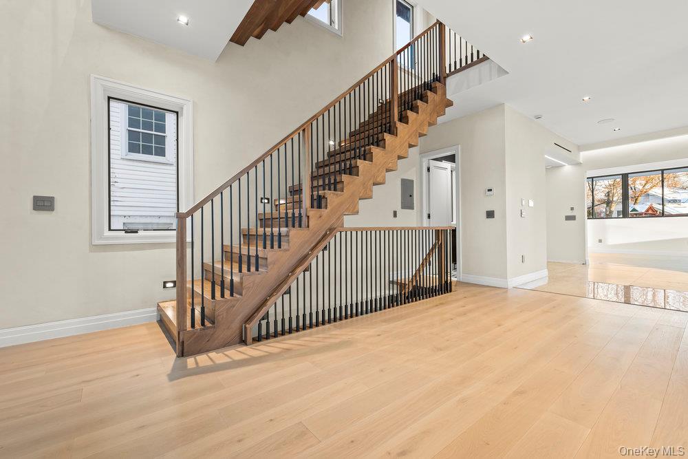 176-12 Kildare Road Queens, NY 11432 - Photo 6 of 34 Stairs featuring wood finished floors, recessed lighting, and a towering ceiling